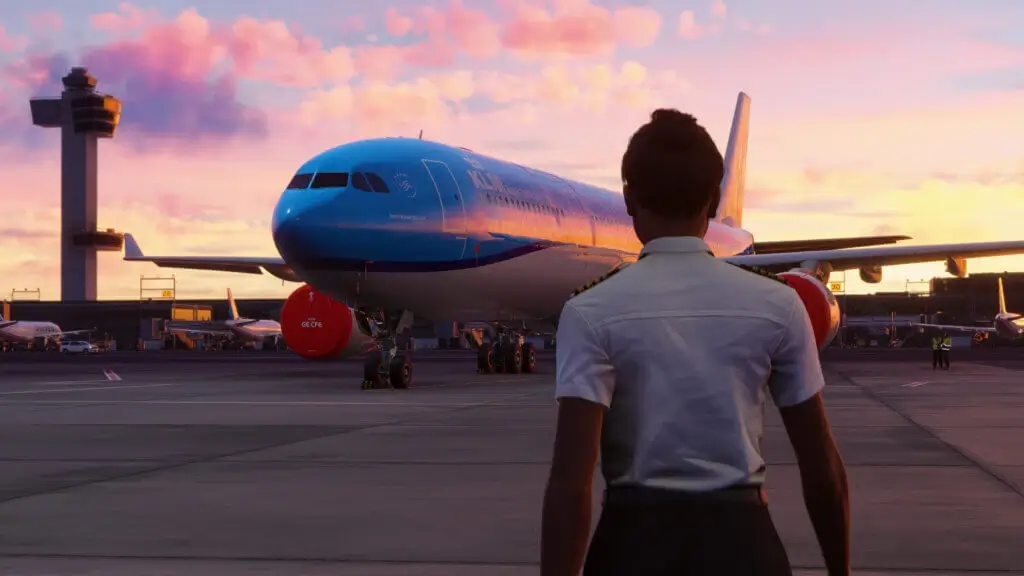 a person standing in front of a blue airplane
