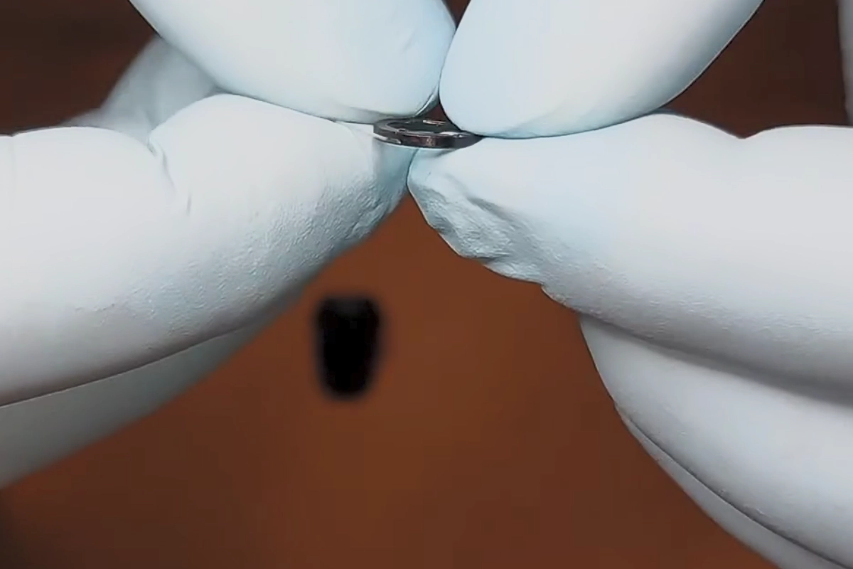 a close up of a hand holding a metal object